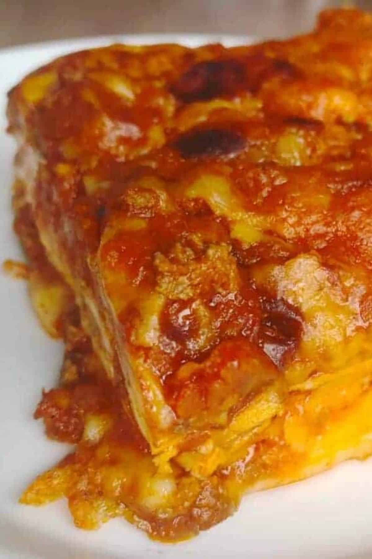 slice of lasagna on a white plate.