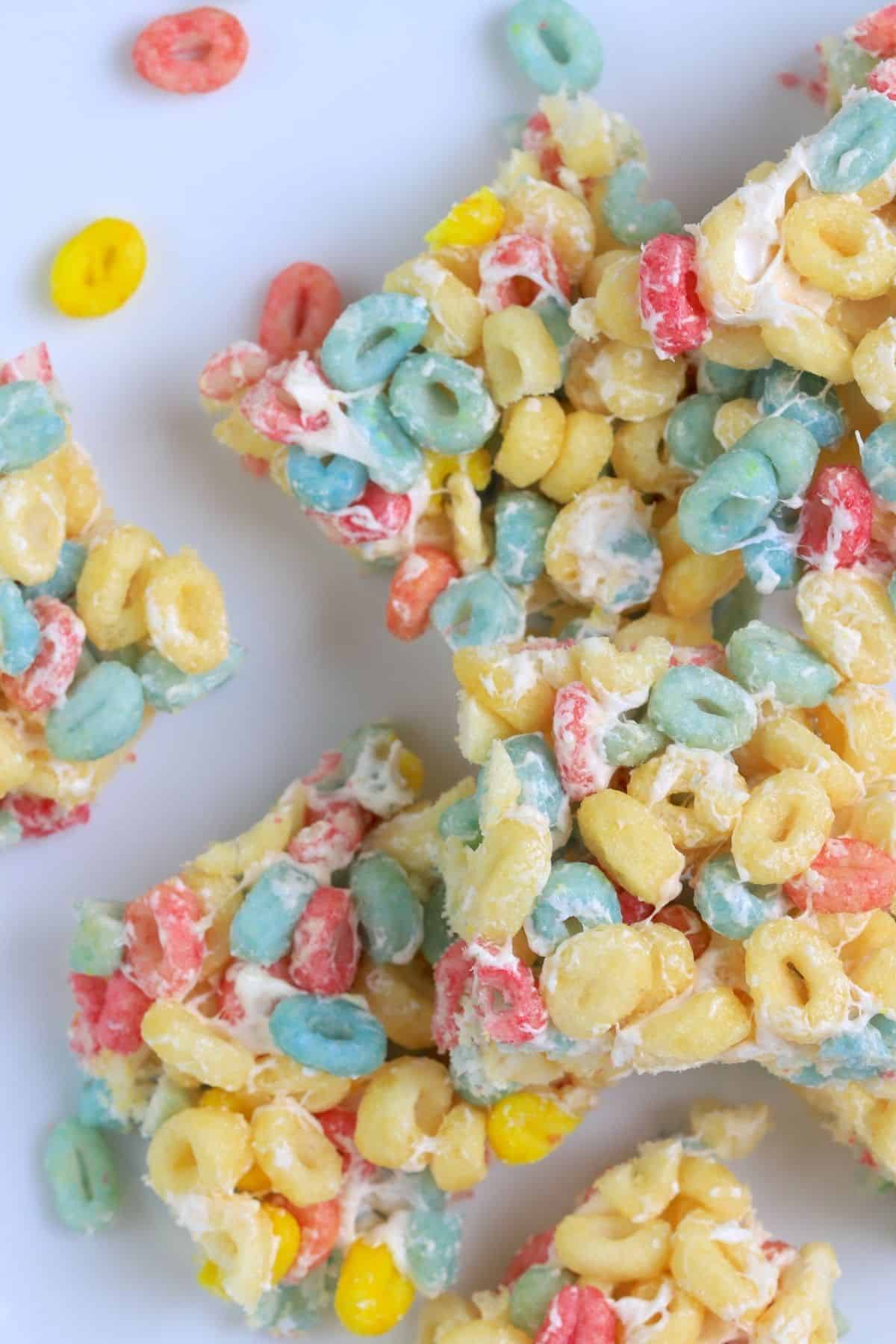 fruity crispy treats cut into squares on parchment paper