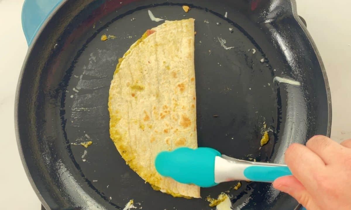 quesadilla on a skillet folded in half.