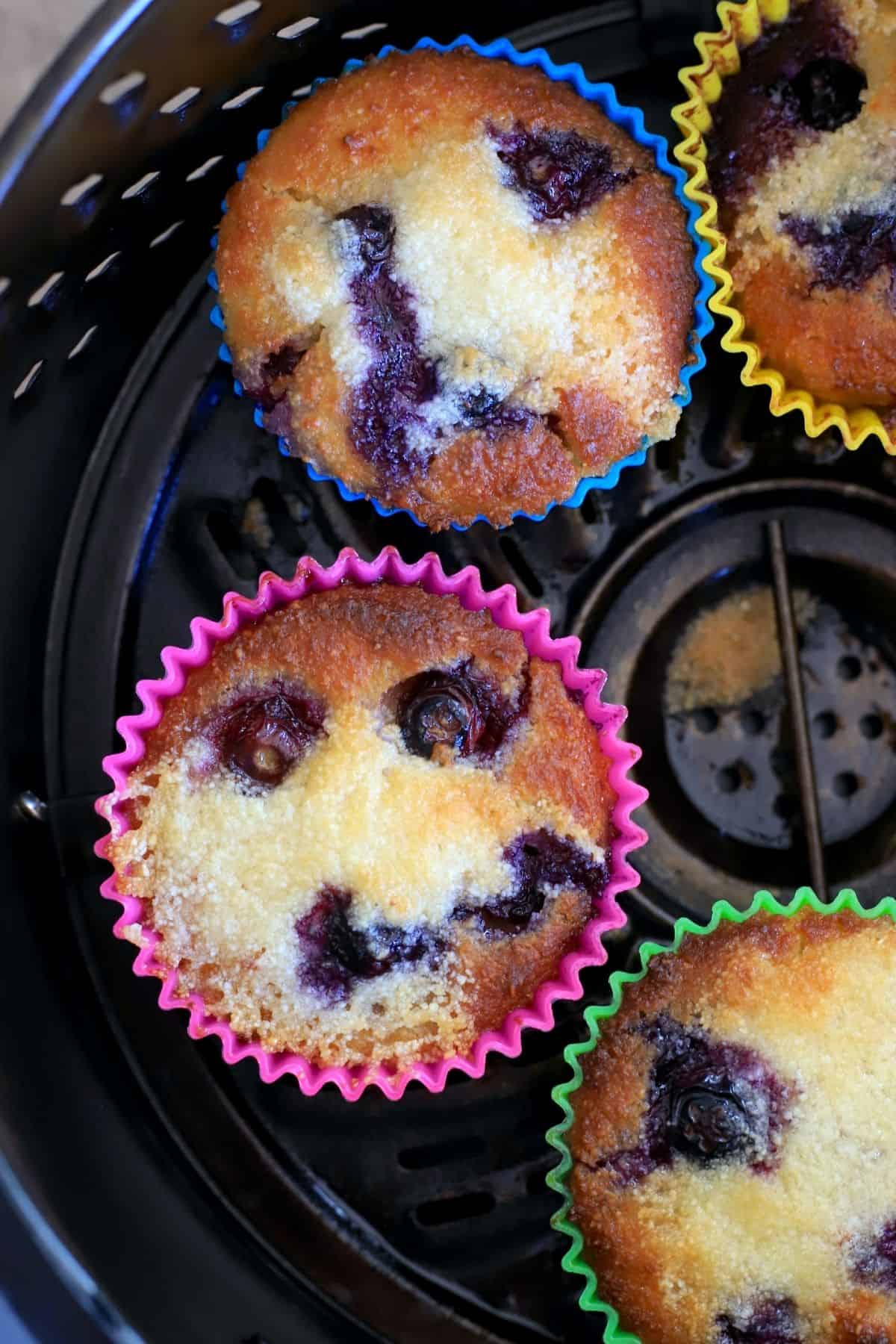 baked low carb blueberry muffins in the air fryer basket.
