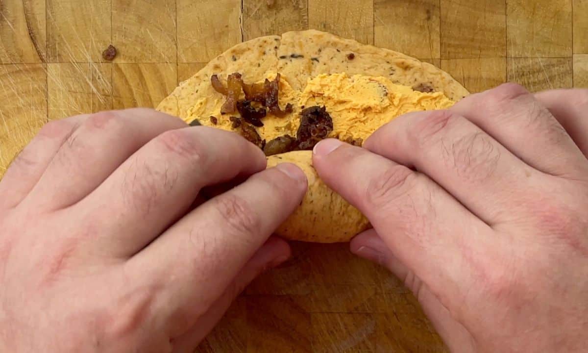 rolling the pinwheel on a cutting board.