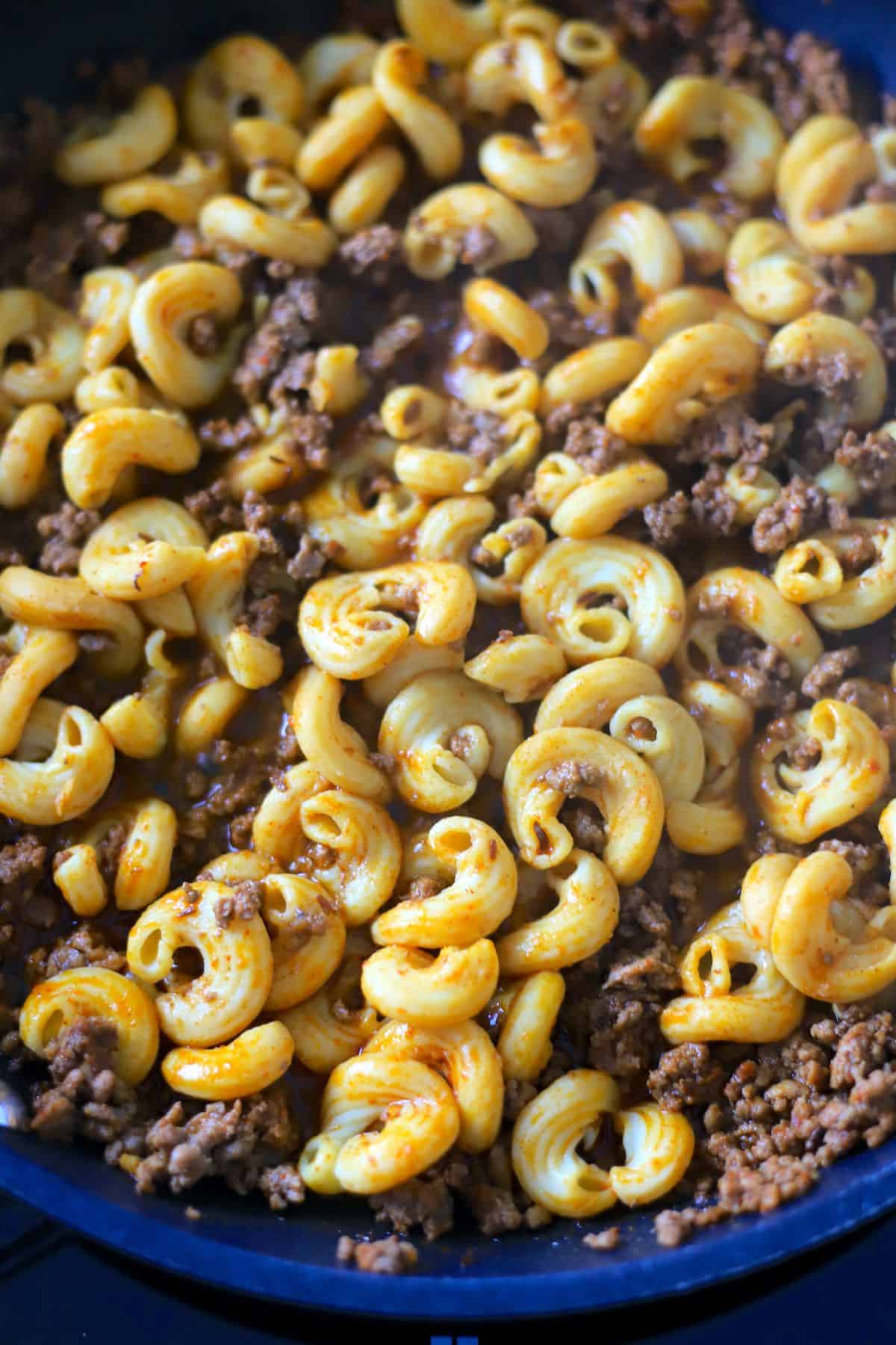 cooked ground meat in a skillet with keto pasta.