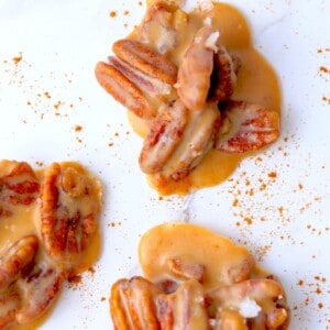 three keto pecan pralines sprinkled with cinnamon.