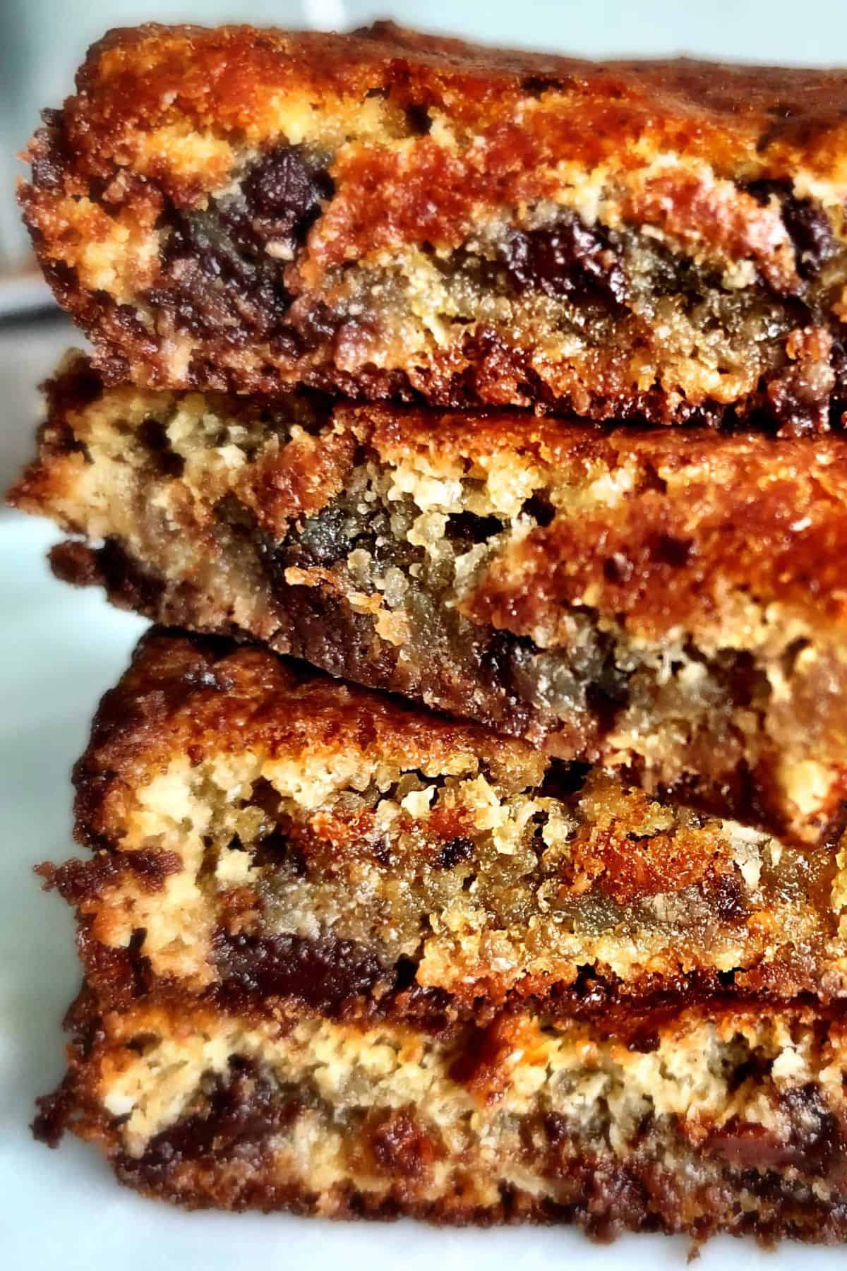 chocolate chip almond flour blondie squares stacked on top of each other.