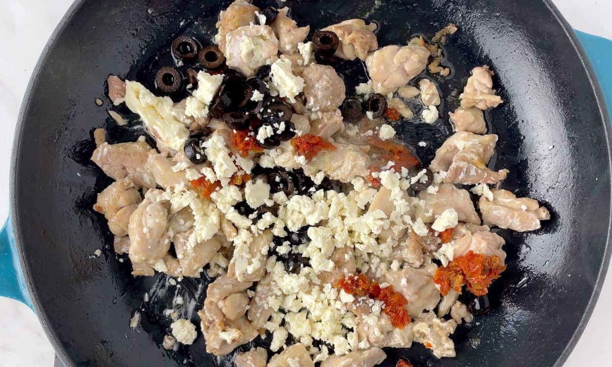 skillet with chicken, feta cheese, olives and sundried tomatoes.