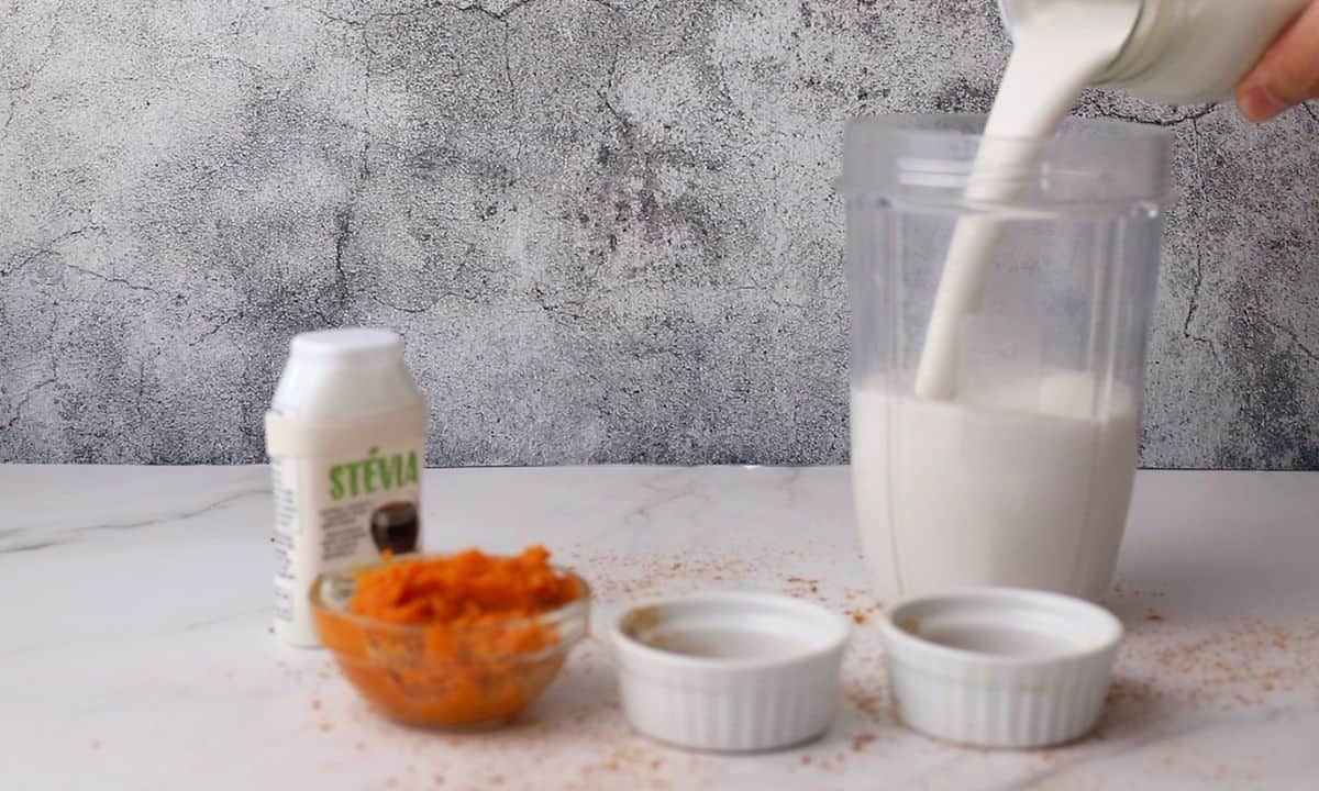 pouring milk into the blender cup.