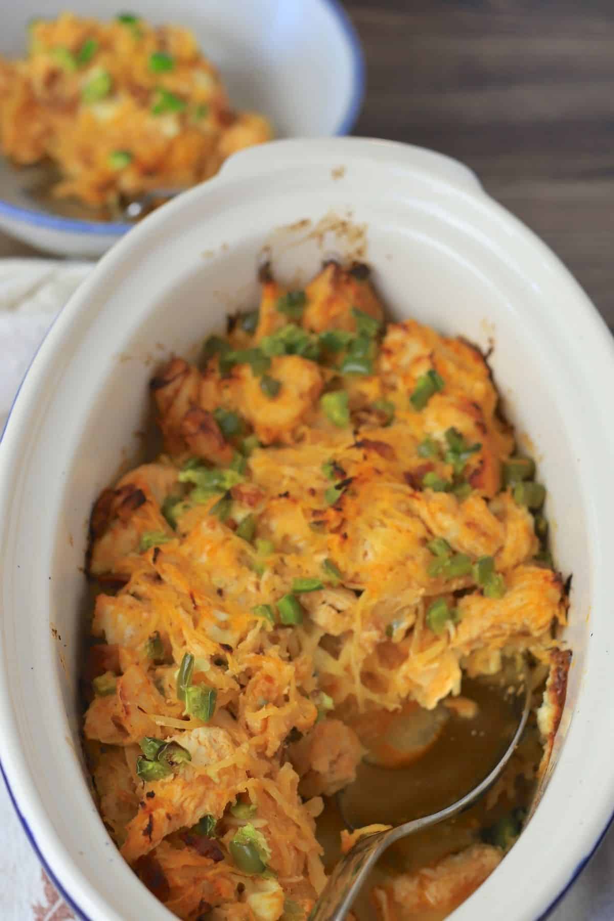 Side bowl and casserole with buffalo chicken spaghetti squash.