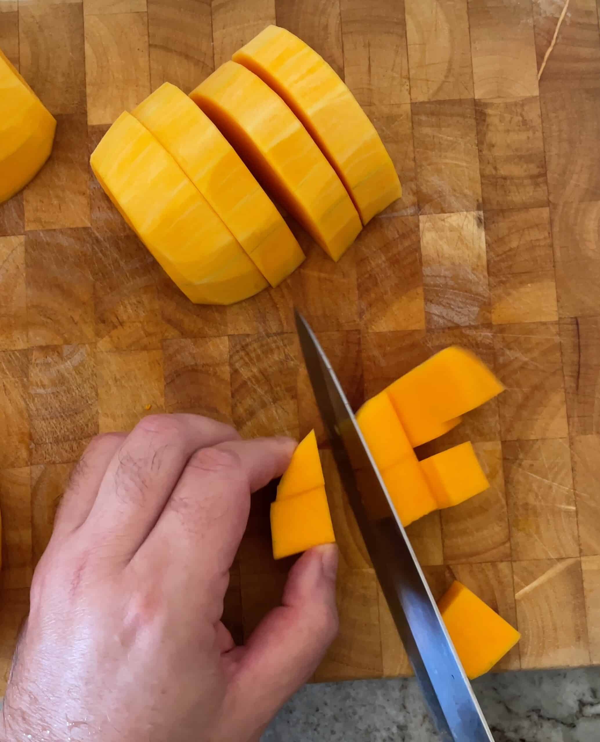 cutting the butternut squash on a cutting board.