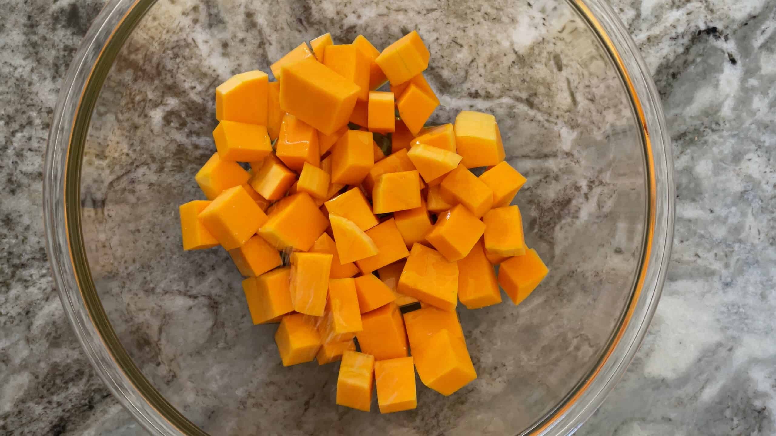 butternut squash cubes in a glass bowl.