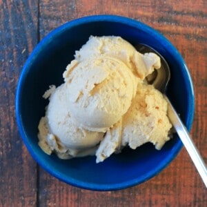 blue bowl with gingerbread ice cream and a silver spoon.