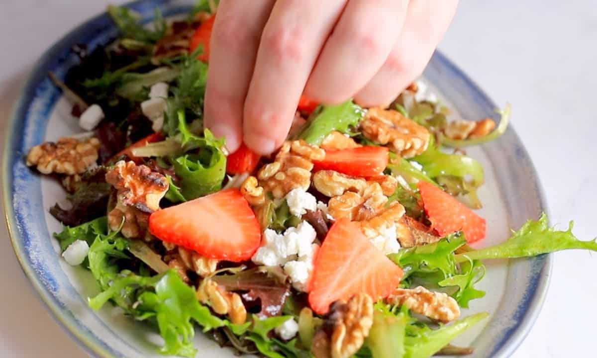 assembling the salad and adding walnuts.