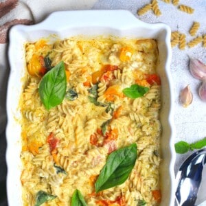 baked goat cheese pasta in a white casserole dish.