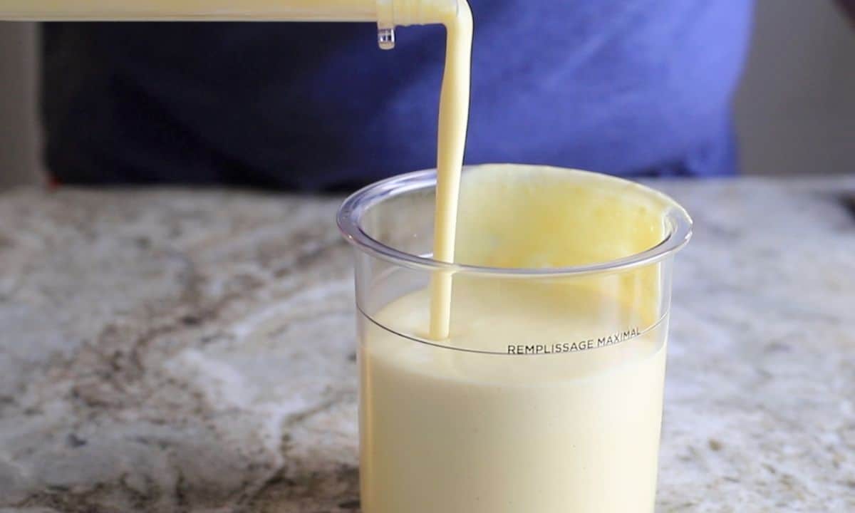 pouring ice cream mixture into a ninja creami pint.