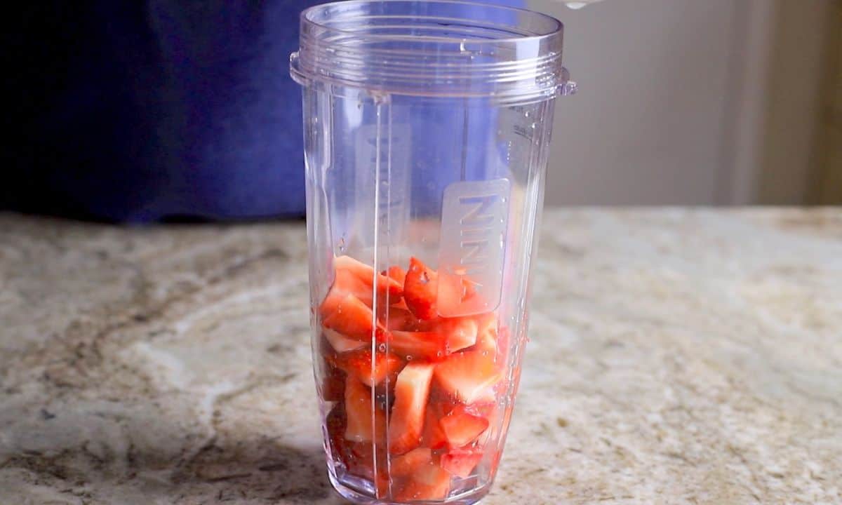 strawberries in a blender cup.