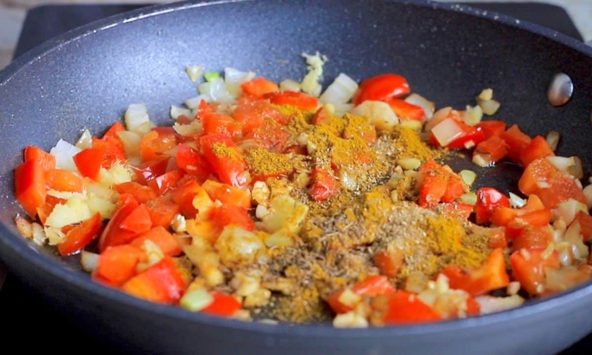 tomatoes, onions and spices in the skillet pan.