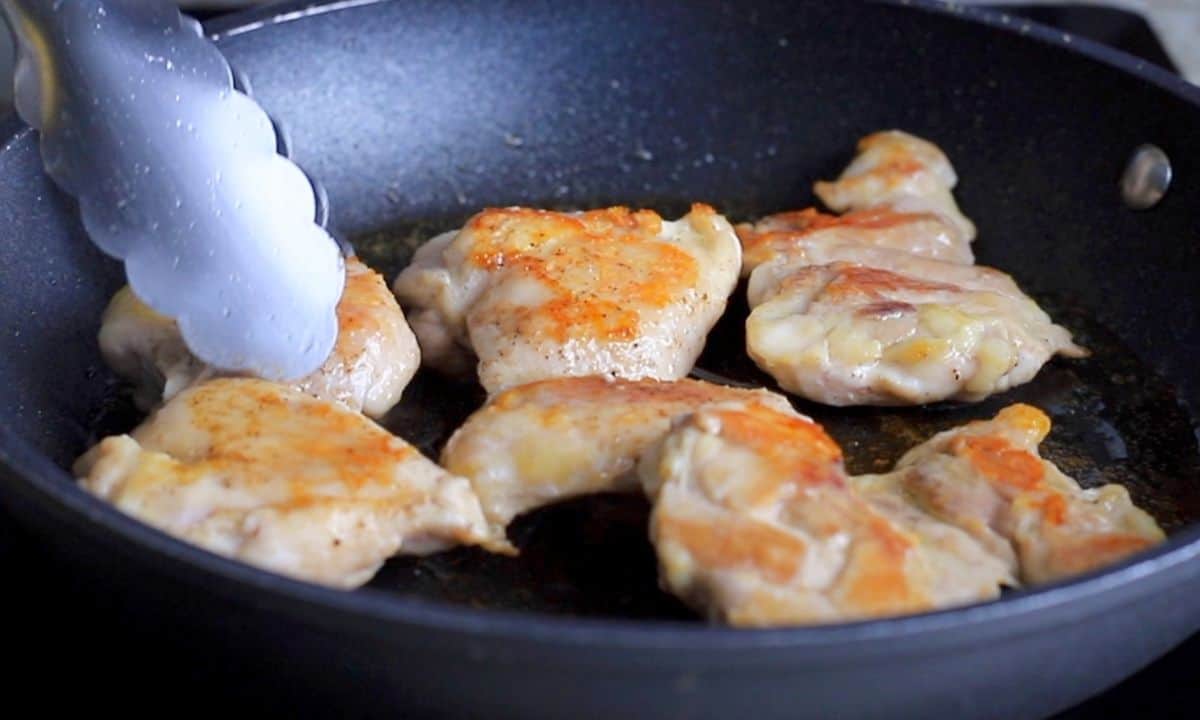 browning chicken in the skillet.