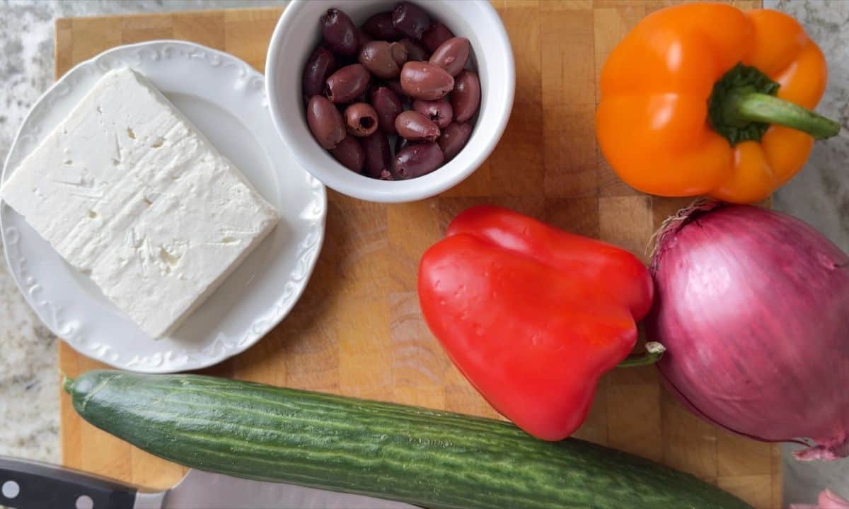 salad ingredients on a wooden cutting board.