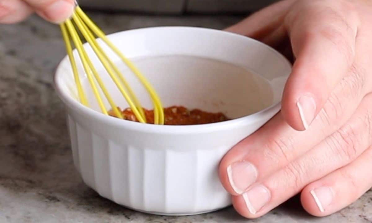 mixing spices in a small white bowl.