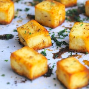 Roasted paneer on a baking sheet sprinkled with chopped cilantro.
