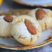 gold rimmed dish with sicilian almond cookies.