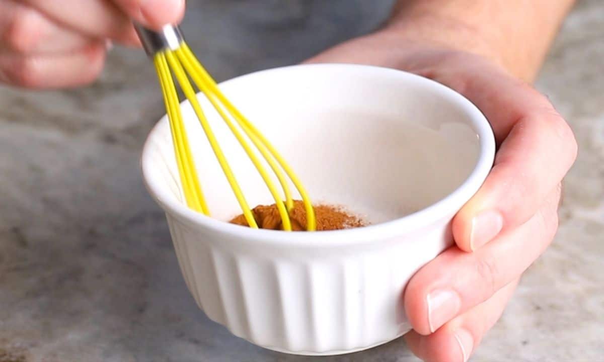 whisking in a white bowl.