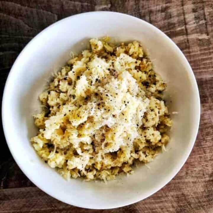 white bowl of keto cacio e pepe on a wooden background.