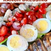 low carb chicken cobb salad with chicken, bacon, tomatoes, sliced boiled eggs and blue cheese.