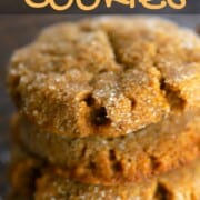 pumpkin spice cookies stacked and laying flat on a cooling rack.