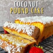 strawberry coconut pound cake on a cooling rack with a strawberry.