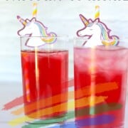 2 tall glasses with unicorn cocktail and unicorn straws.