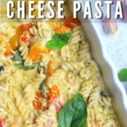 baked goat cheese pasta in a white casserole dish.