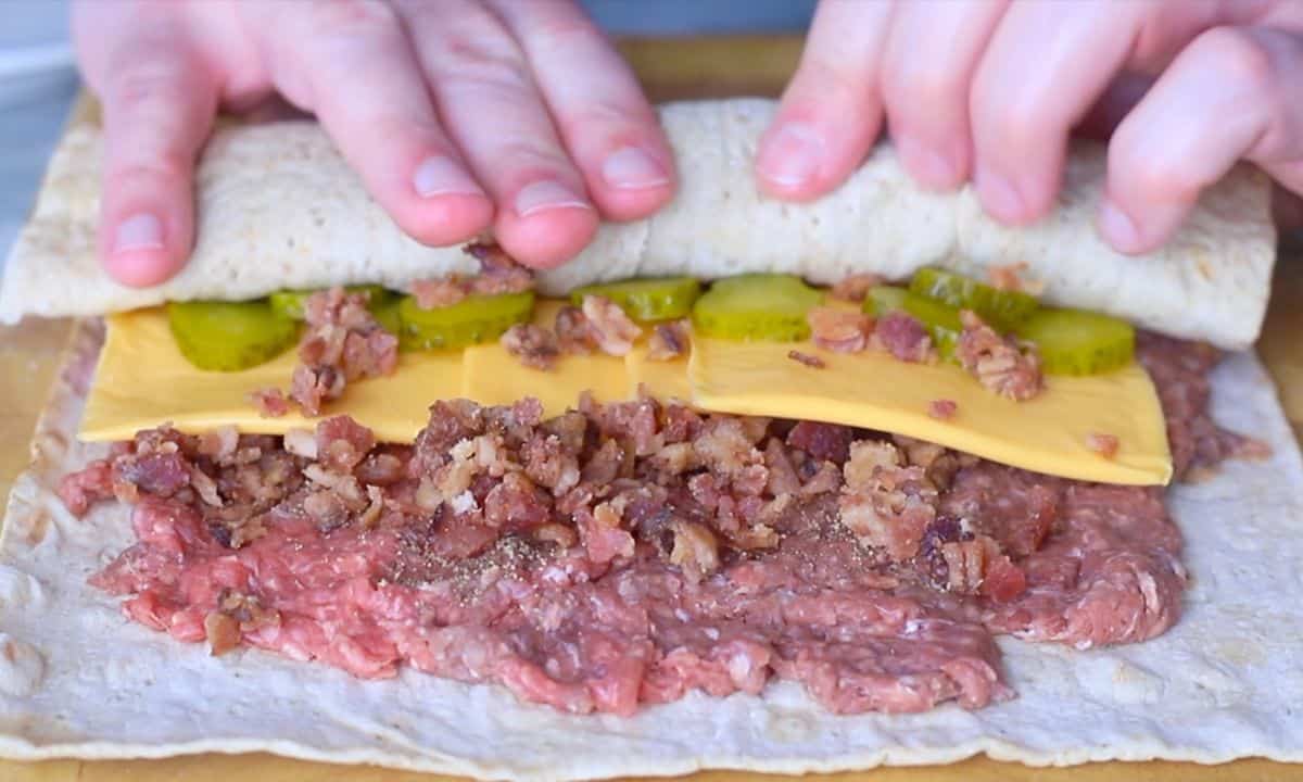 rolling the cheeseburger roll ups.