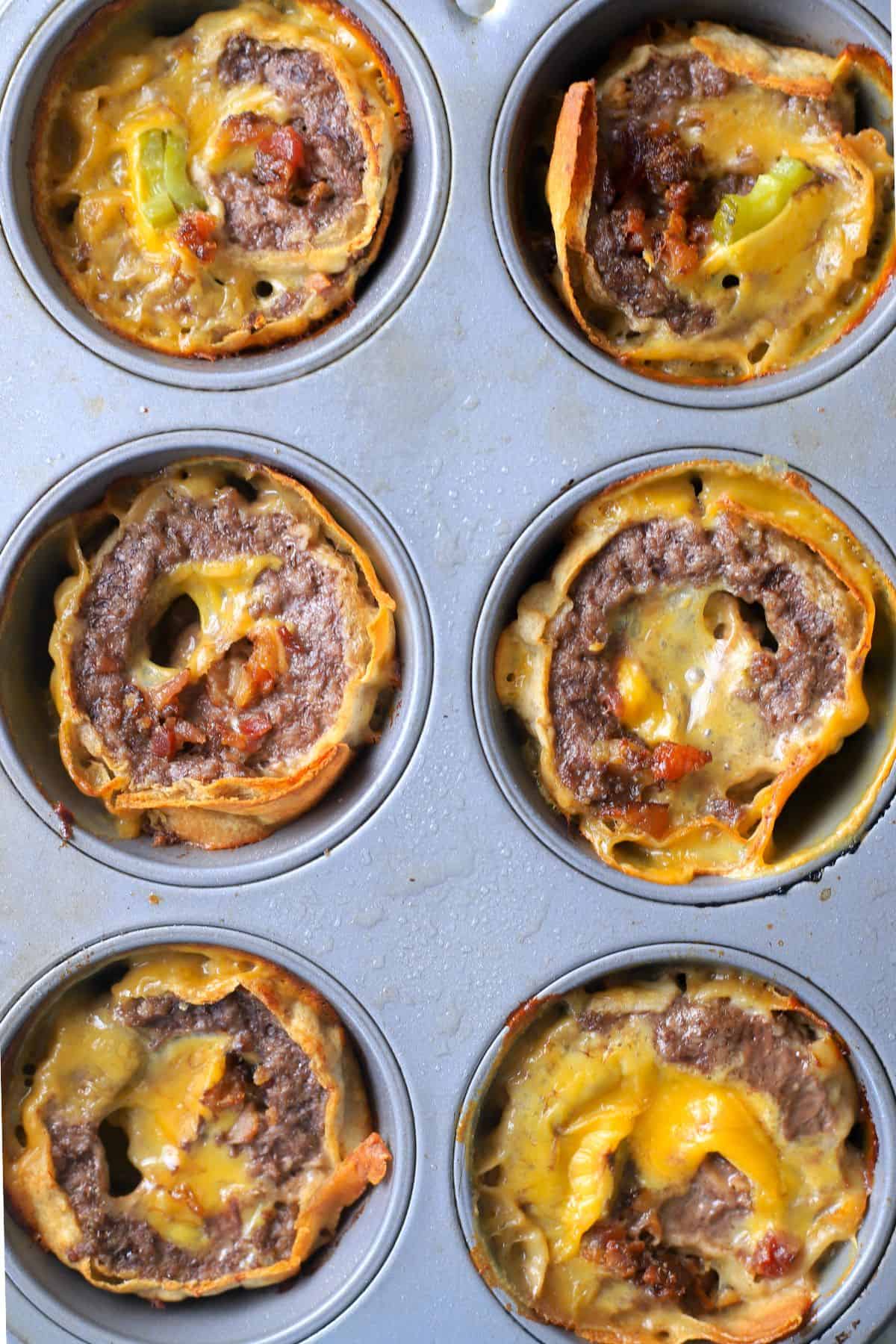 muffin tin with baked cheeseburger roll ups.