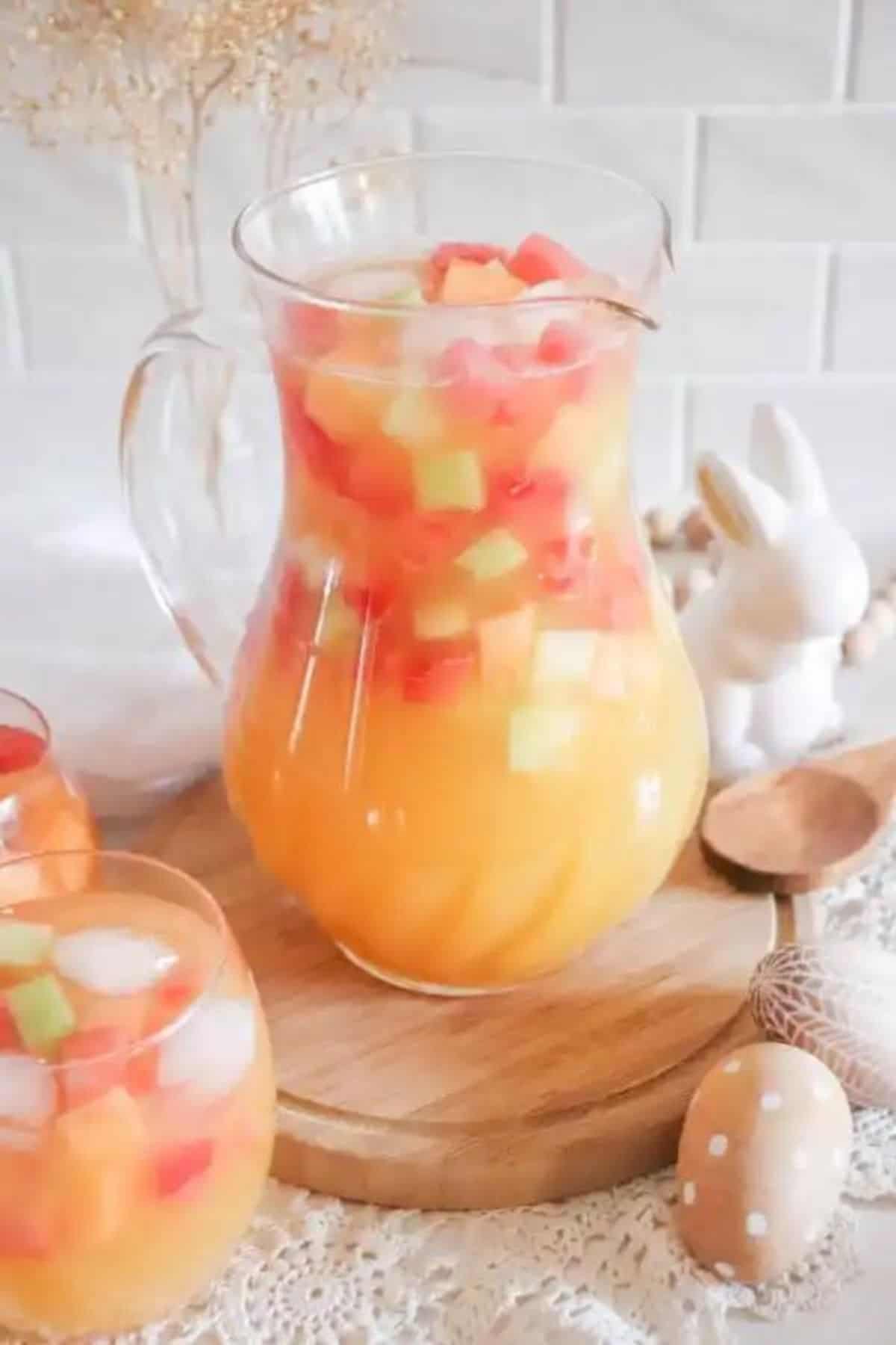 Large jug with easter punch and 2 full glasses on the side.
