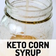 a spoon dripping keto corn syrup into a jar.