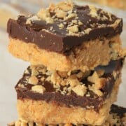 three stacked low carb no bake peanut butter bars.