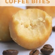 Maple protein coffee bites in a bowl lined with crumpled parchment paper next to a cup of coffee.