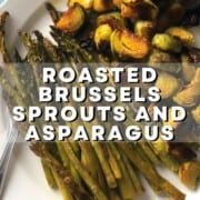 roasted brussels sprouts and asparagus on a blue rimmed dish with a serving spoon.