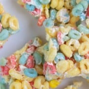 fruity crispy treats cut into squares on parchment paper