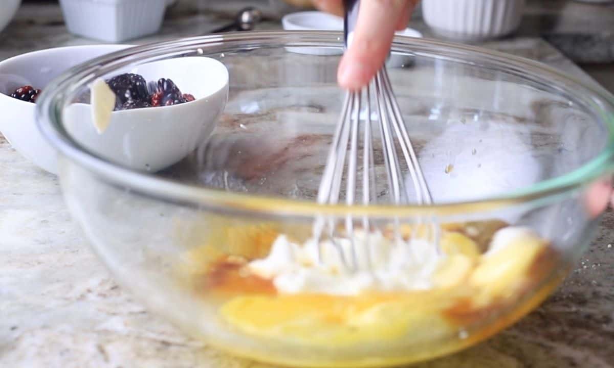 mixing the wet ingredients in a glass bowl.