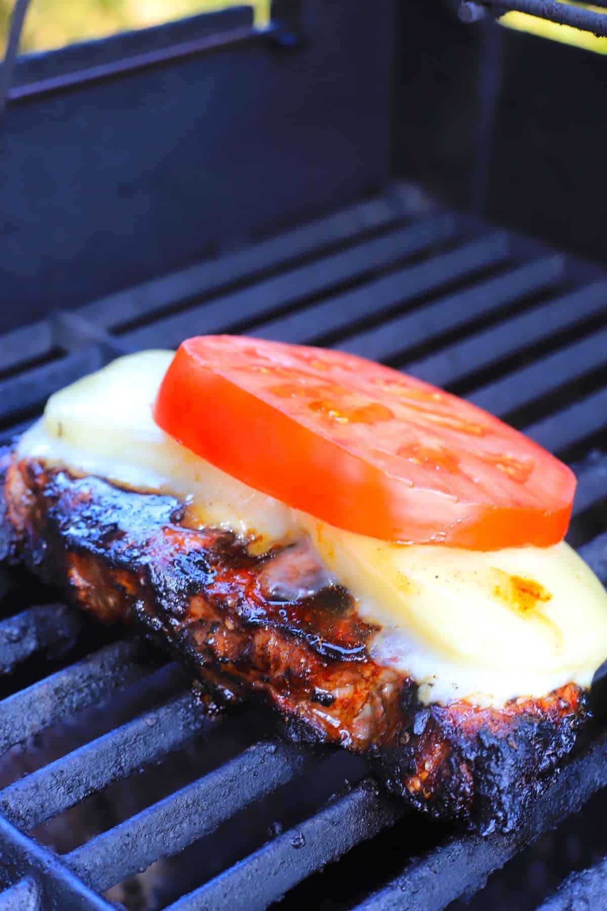 caprese steak on the grill.