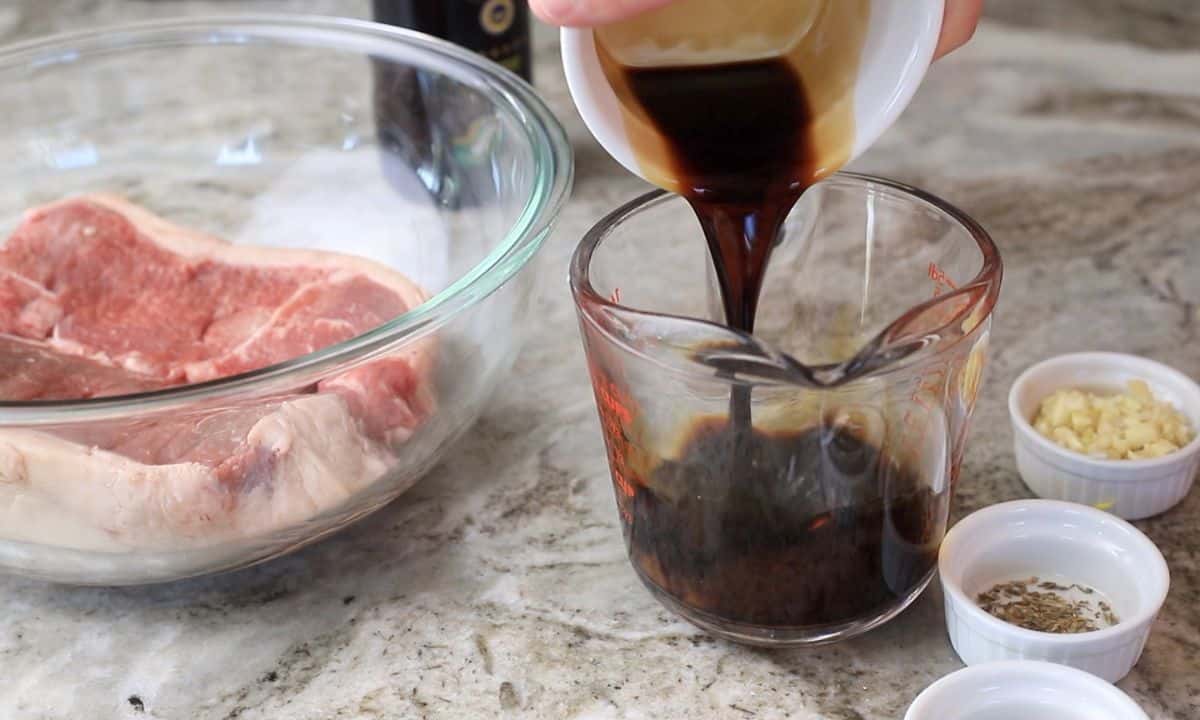 pouring the balsamic into a measuring cup.