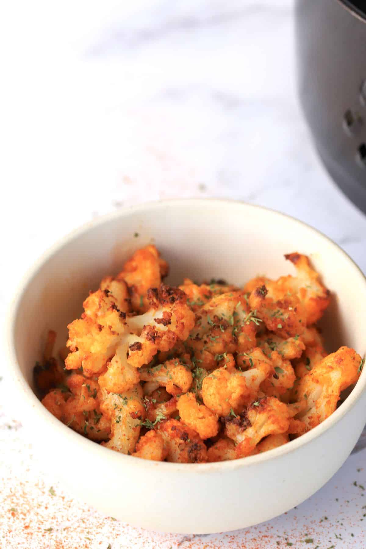 Roasted cauliflower in a white bowl.