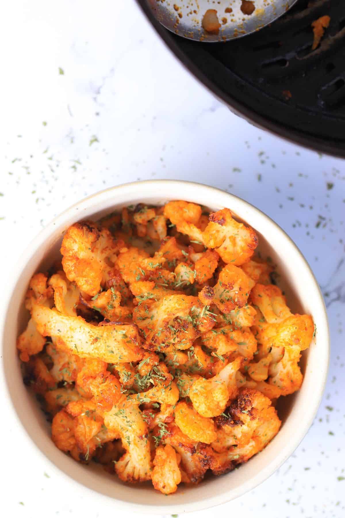 Roasted cauliflower in a white bowl.