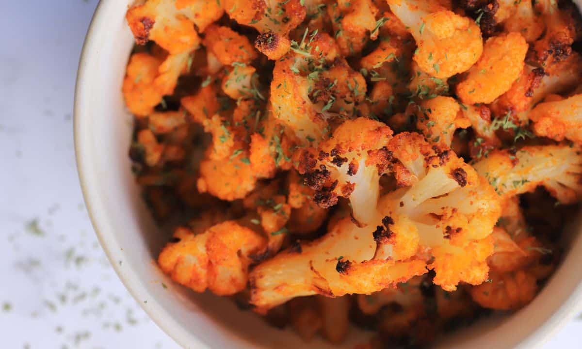 Roasted cauliflower in a white bowl.