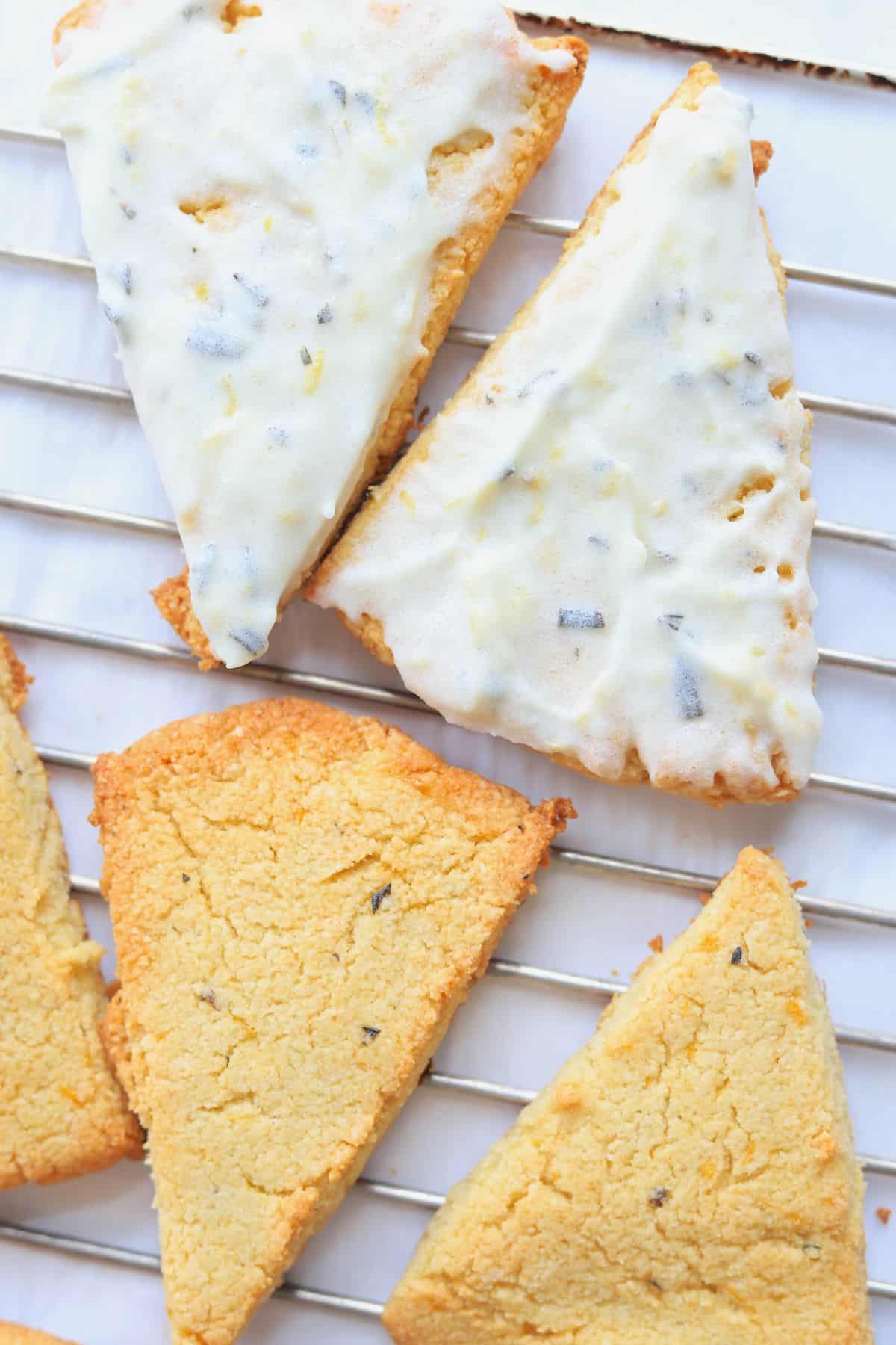 4 Almond flour scones on a cooling rack with a lemon rosemary frosting.