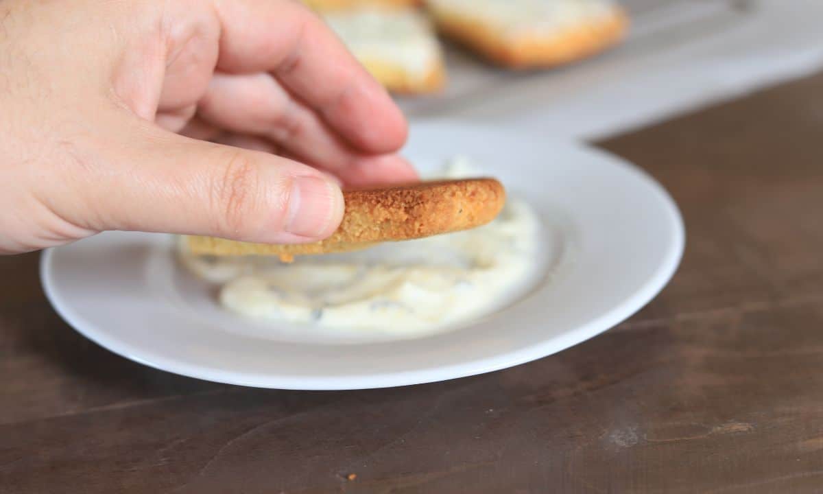 dipping the scones into the glaze.