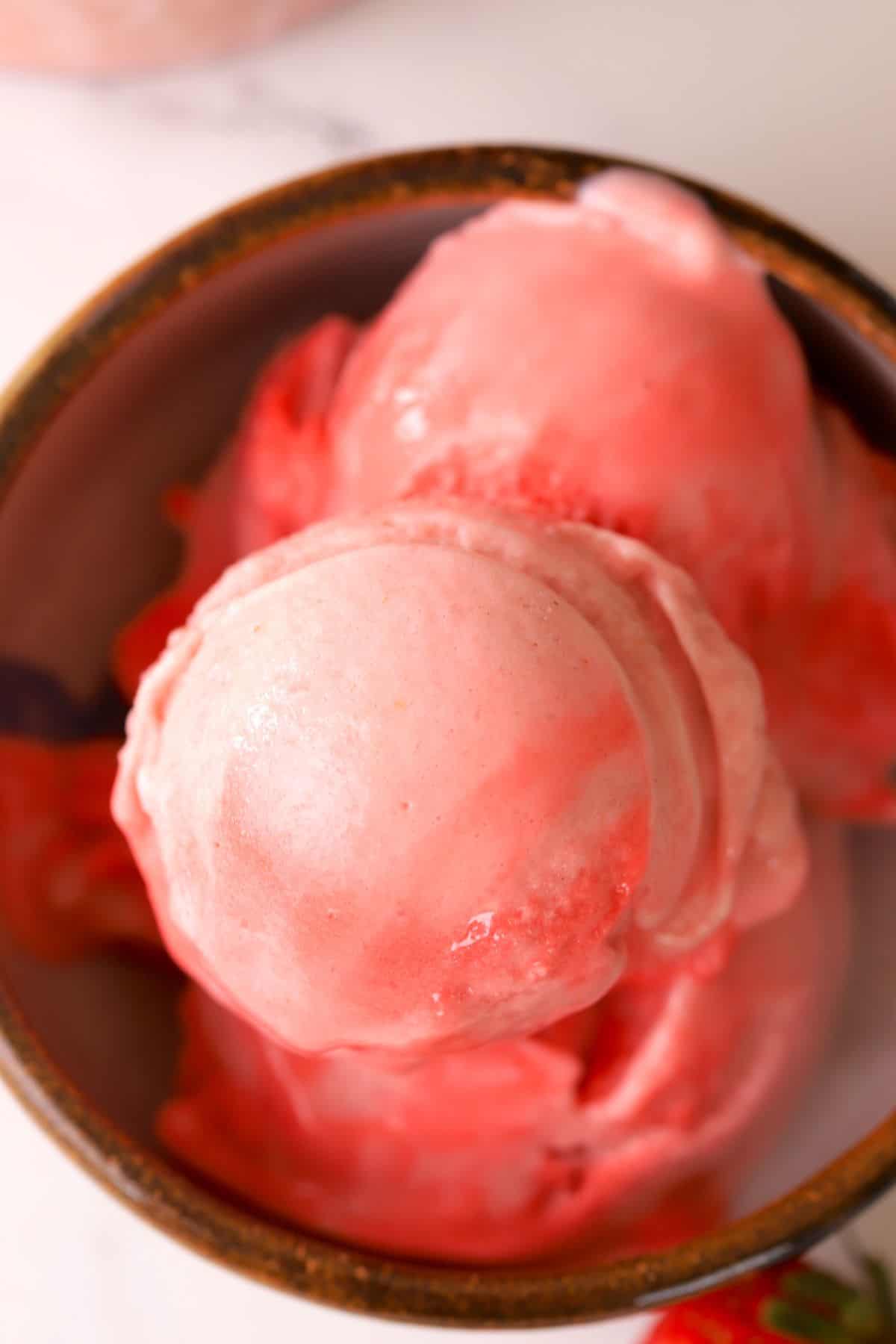 Close up of the strawberry ice cream in a bowl.