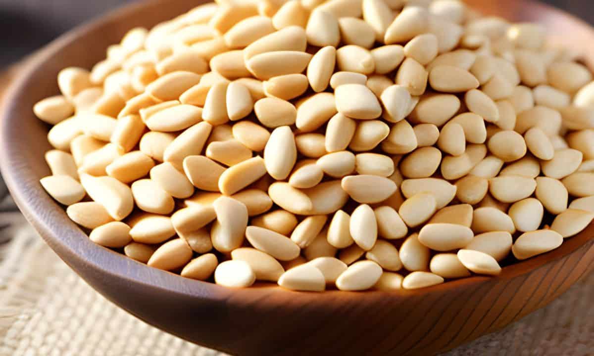 pine nuts in a brown wooden bowl.