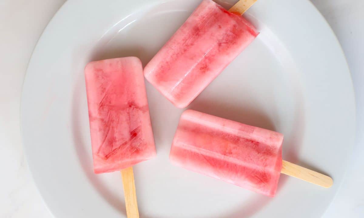 Three sugar free popsicles on a white plate.